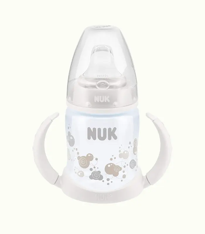 Nuk - Biberón de aprendizaje con boca de silicona, diseño de fuegos artificiales, color blanco